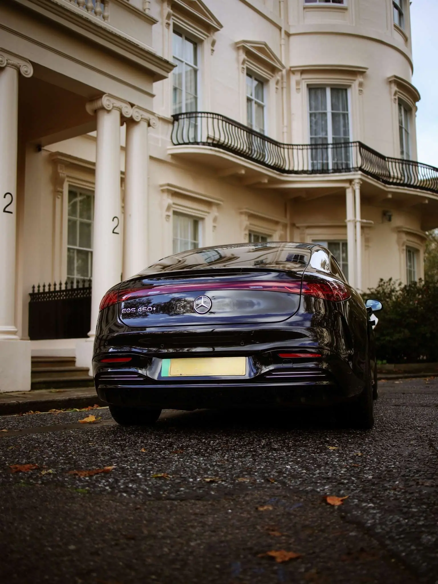 Rear of a Mercedes EQS 450+ outside a Regency London townhouse