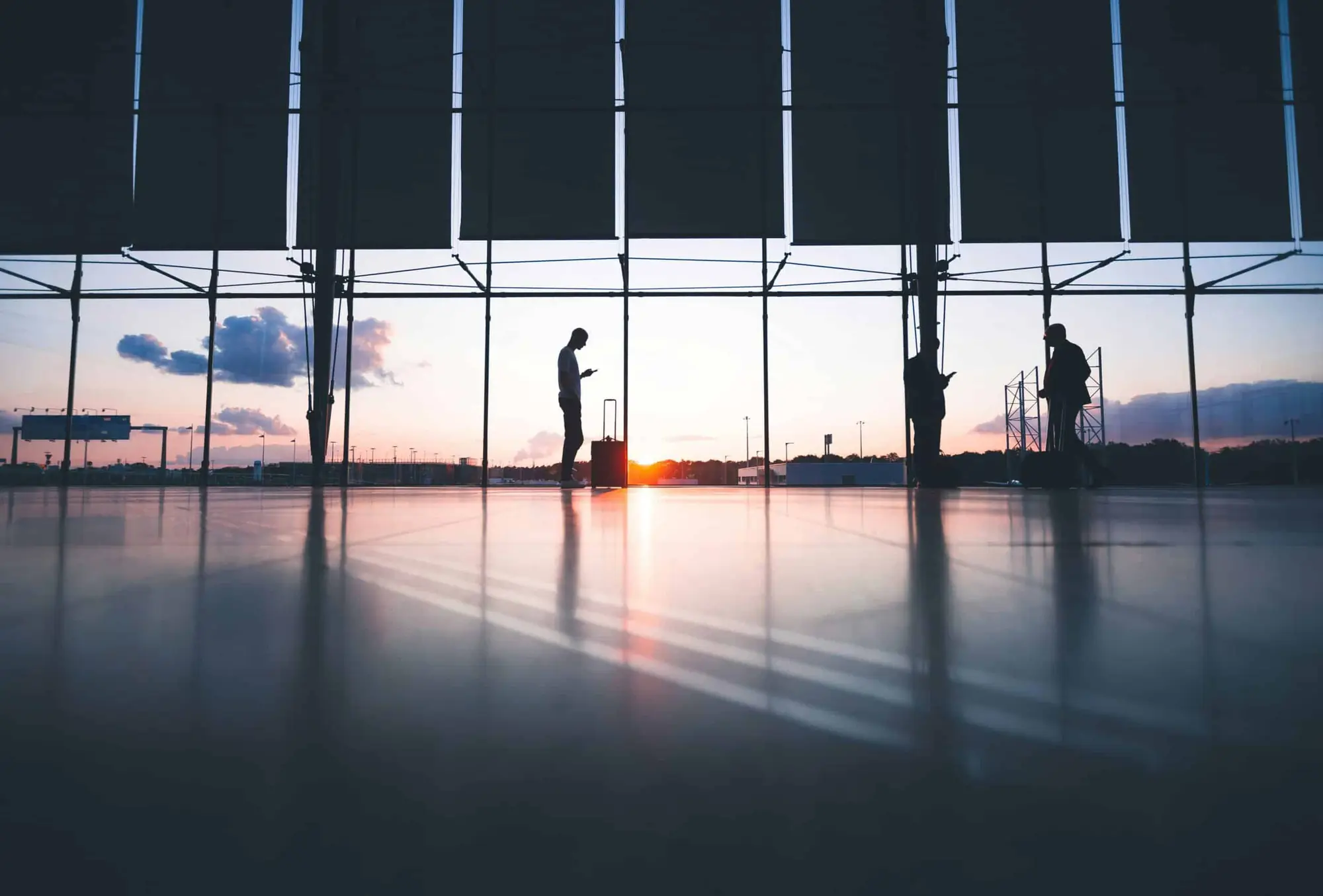 Silhouettes against floor-to-ceiling windows overlooking London