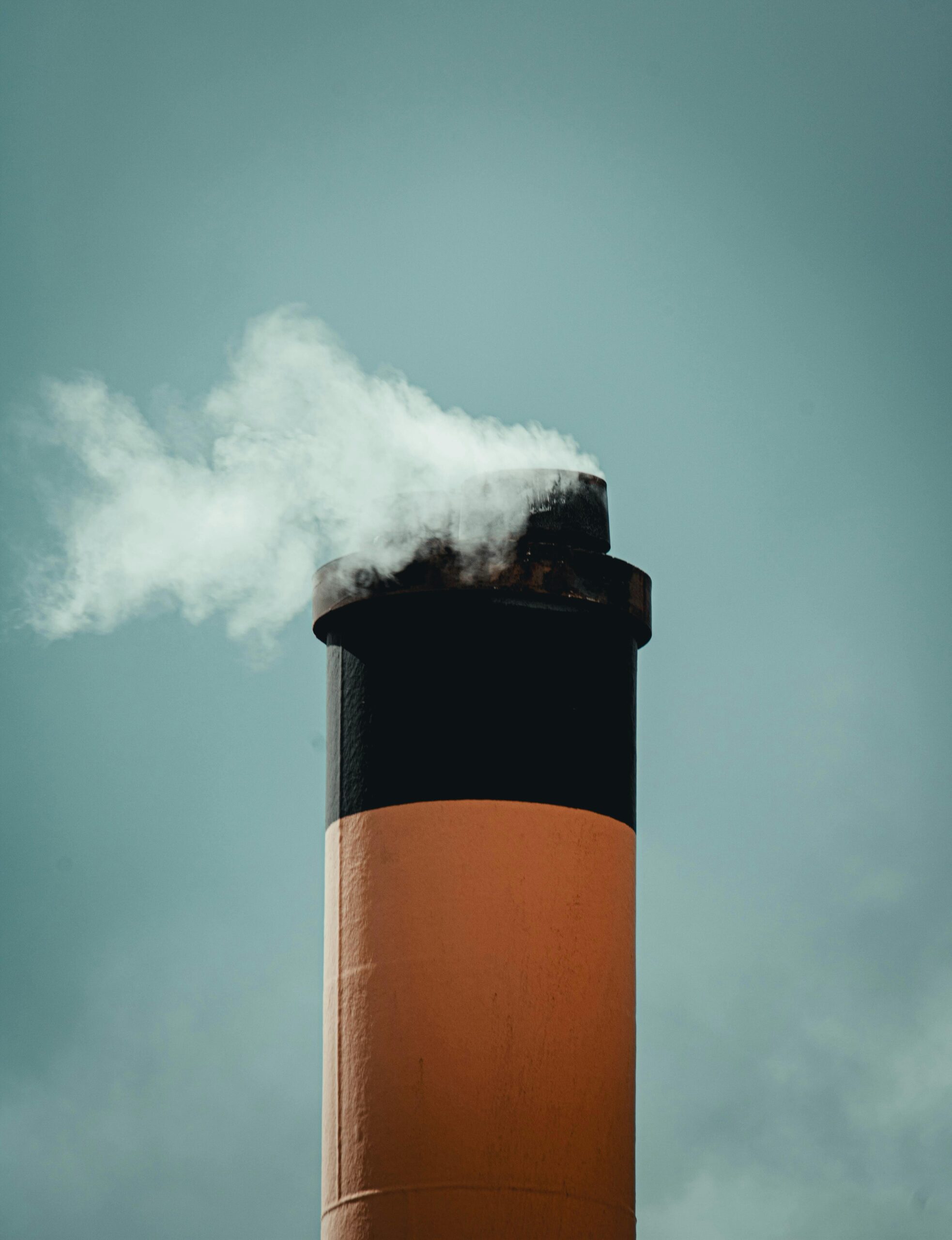 Our-Impact-So-Far-Section/Eco-Chauffeuring-Page white smoke coming out of a factory chimney