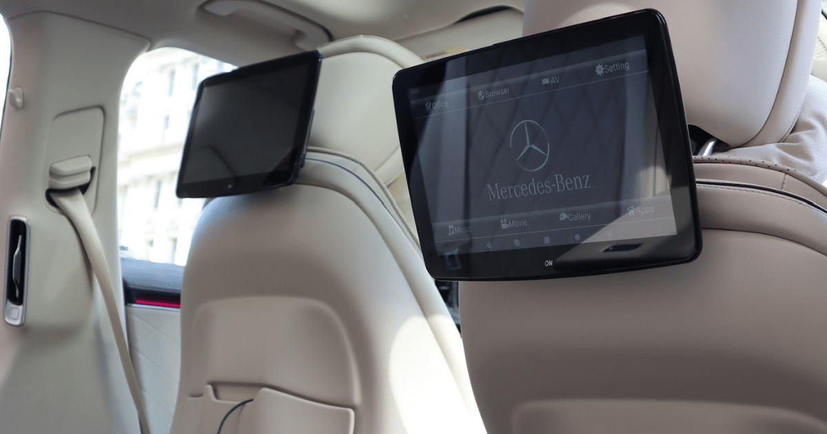 A car's back seat with a tablet placed on it, ready for use